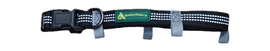 A black pet harness with white reflective stripes, gray webbing straps, and a green 'BuddyRider' logo patch on the front.